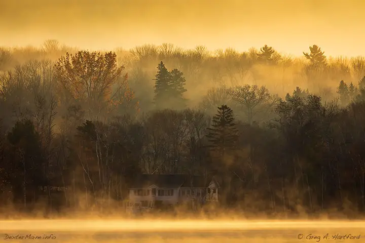 This is a sunrise looking across the small Lake Wassookeag in Dexter on a foggy morning.