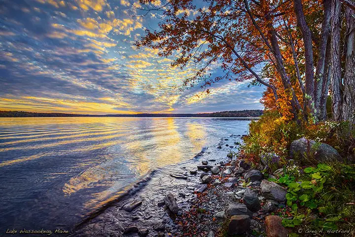 The shows a beautiful autumn sunset on Big Lake Wassookeag in Maine.